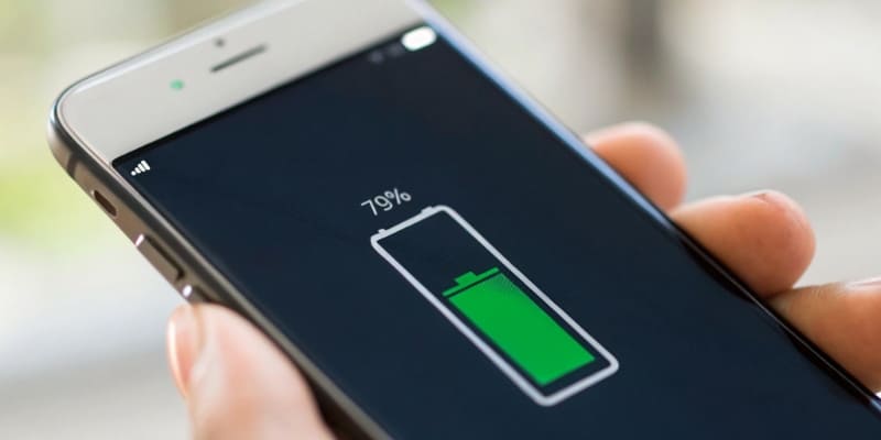 A swollen lithium battery placed next to a new, flat one for comparison