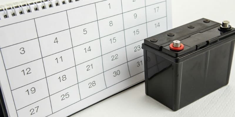 A calendar marking years next to a lithium battery