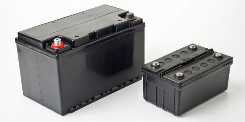 A swollen lithium battery next to a normal one