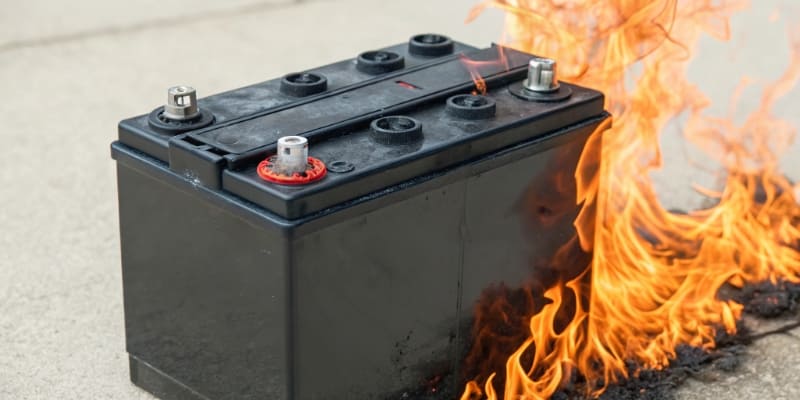 An illustration of an NMC battery cell with heat and flame graphics around it