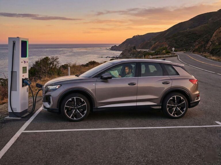 Electric vehicle charging roadside at sunset